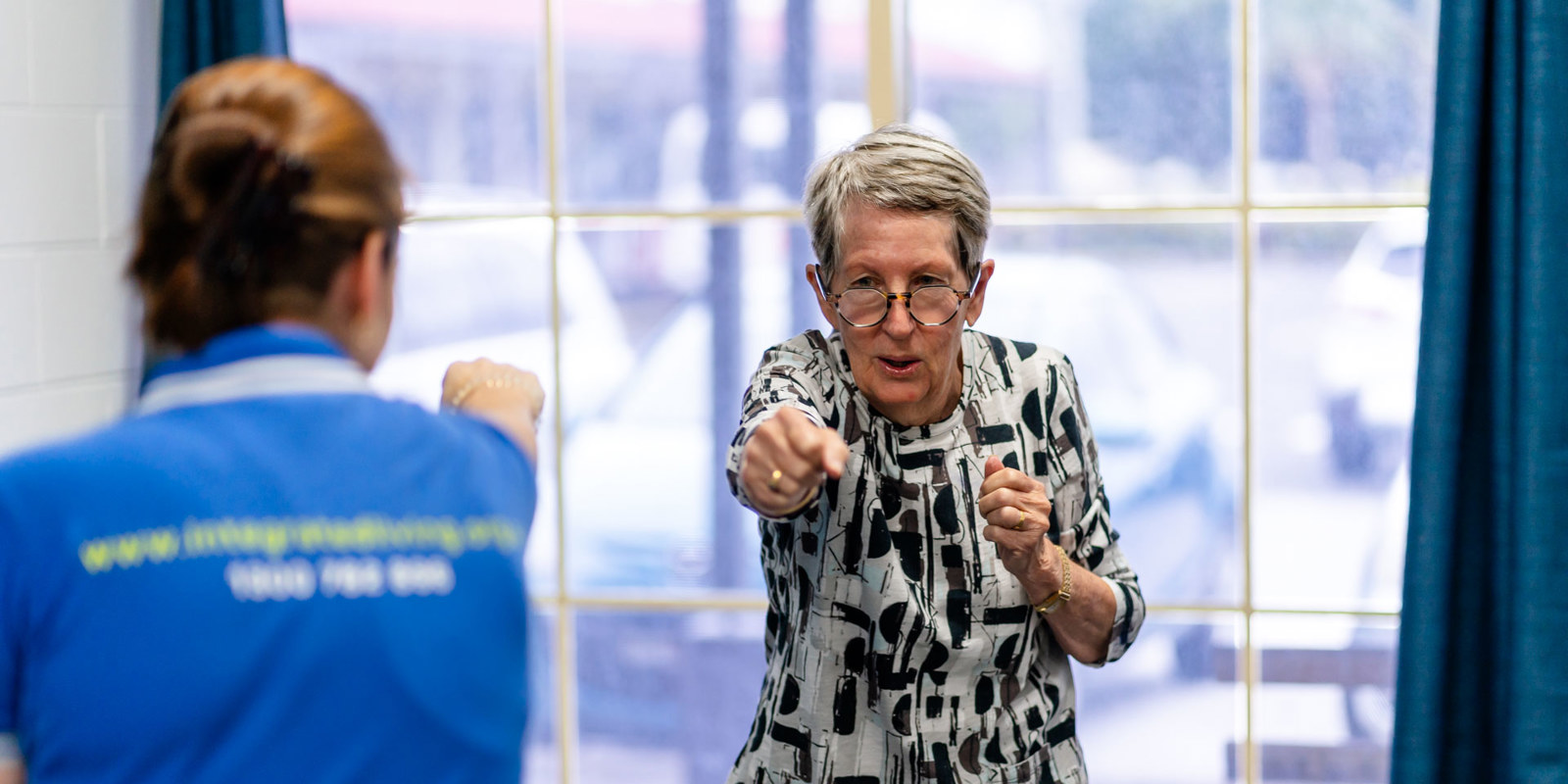 client doing exercises with team member