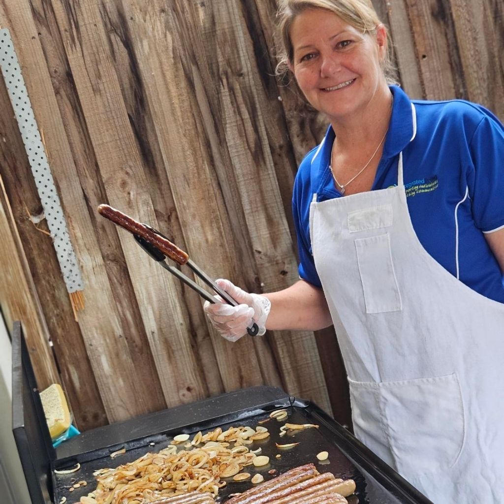 Activity Centre team member cooking a BBQ for clients